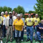 Group of visitors standing on a landscaped outdoor miniature golf course at Brookside Miniature Golf in Branson, Missouri